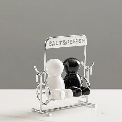 Creative black and white people salt shaker set with shaker on a swing for charming table decor