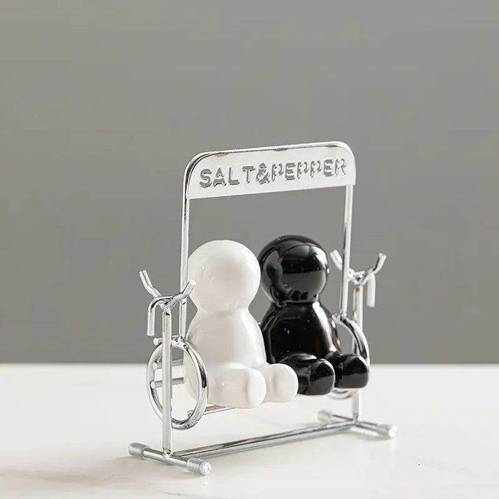 Creative black and white people salt shaker set with shaker on a swing for charming table decor