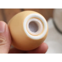 Peach-colored egg-shaped ceramic salt shakers from Pun-tastic Egg-Shaped collection