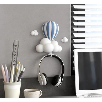 Headphones hanging from a cloud-shaped hook.
