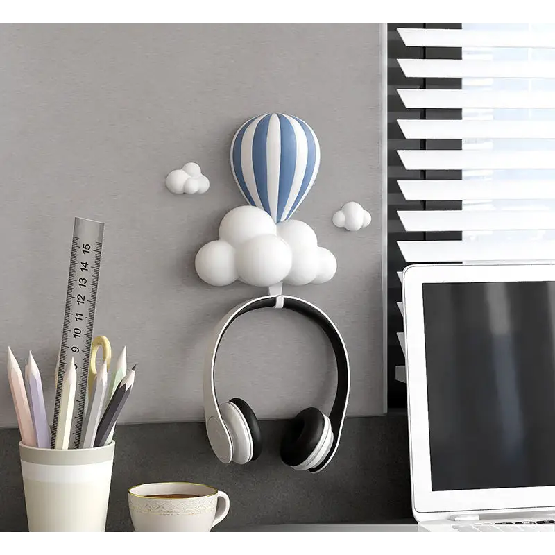 Headphones hanging from a cloud-shaped hook.