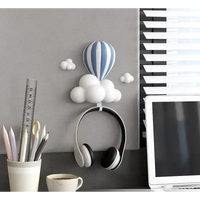 Headphones hanging from a cloud-shaped hook.