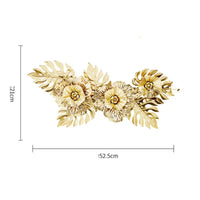 Gold-colored metal floral wall decor.