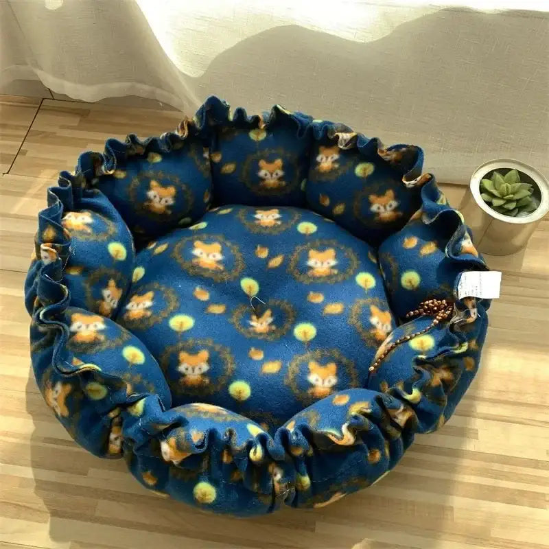 Blue fox-patterned pet bed with ruffled edge.