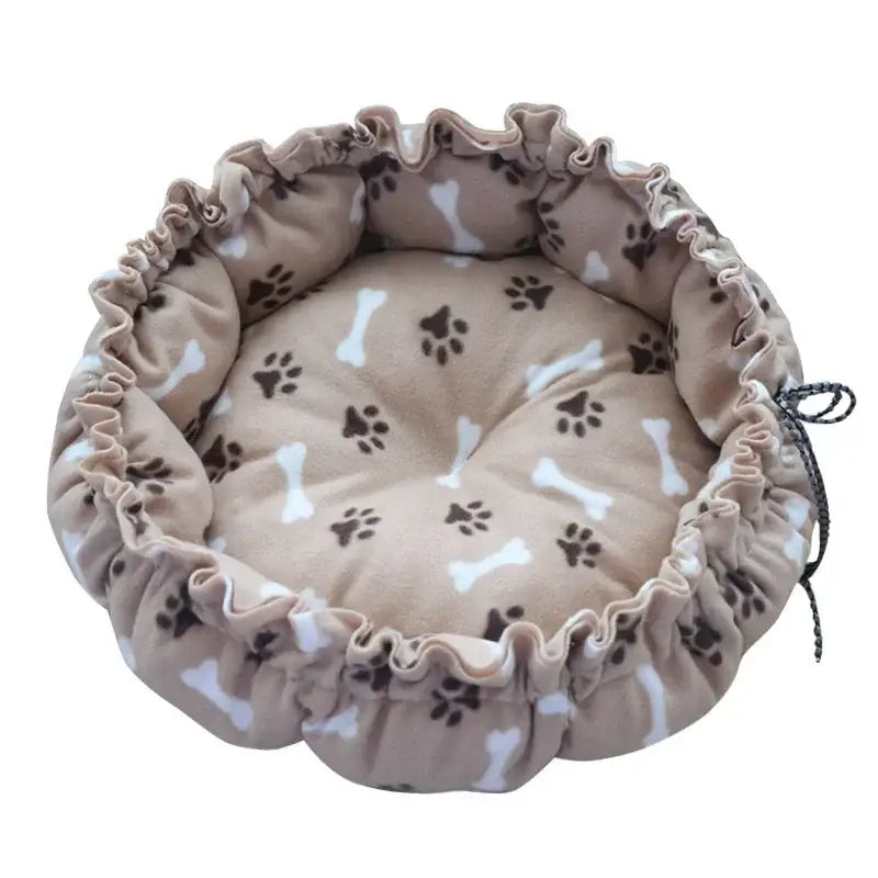 Round pet bed with paw and bone pattern.