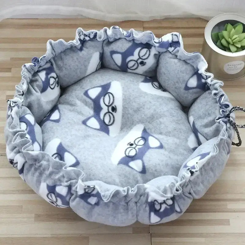 Round pet bed with cartoon dog pattern.