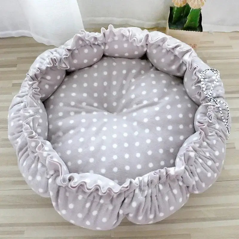 Round, gray, polka-dotted pet bed.