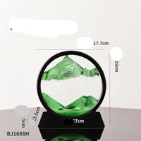 Green sand art in a black circular frame on a black base.