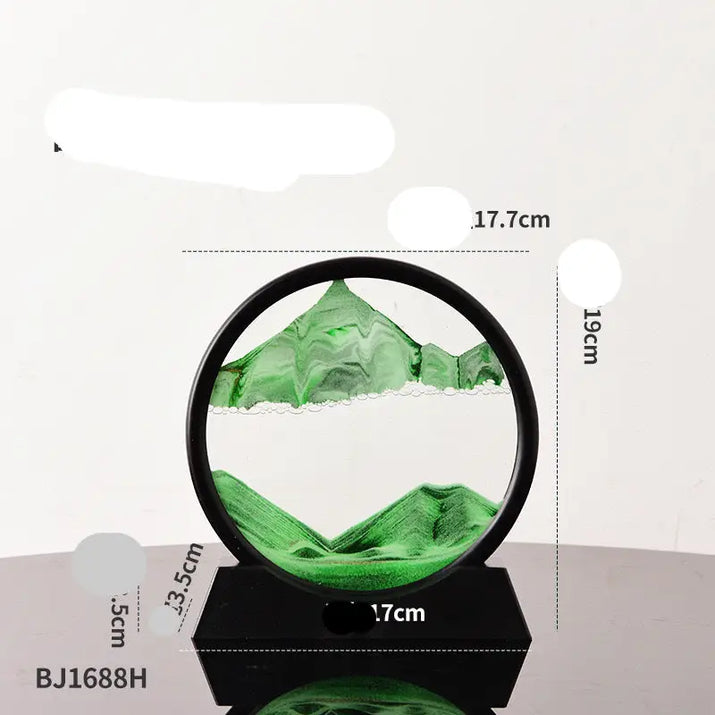 Green sand art in a black circular frame on a black base.