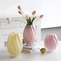 Three pastel-colored, swirled glass vases.