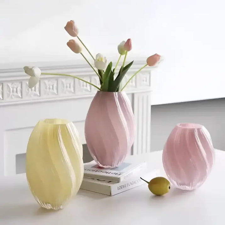 Three pastel-colored, swirled glass vases.