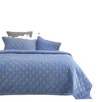 Blue quilted bedspread with matching pillows.