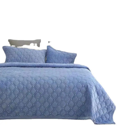 Blue quilted bedspread with matching pillows.