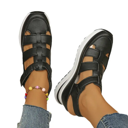 Black leather gladiator sandals.