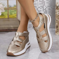 Gold-colored platform sandals.