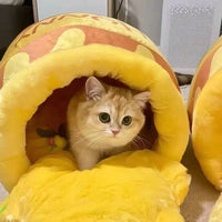 Cat inside a yellow plush pet bed.
