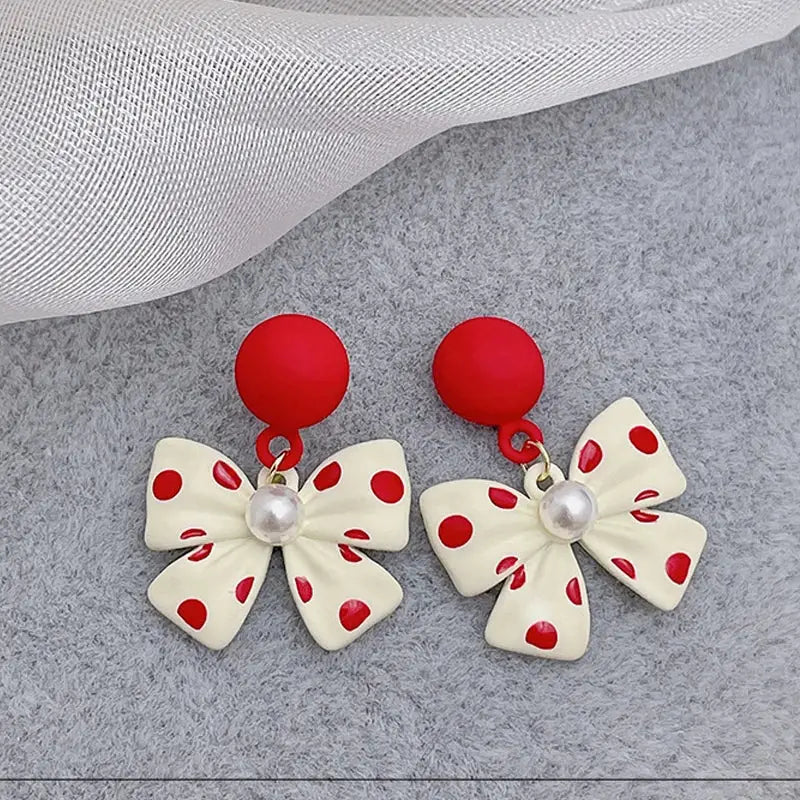 Red and cream polka dot bow earrings.