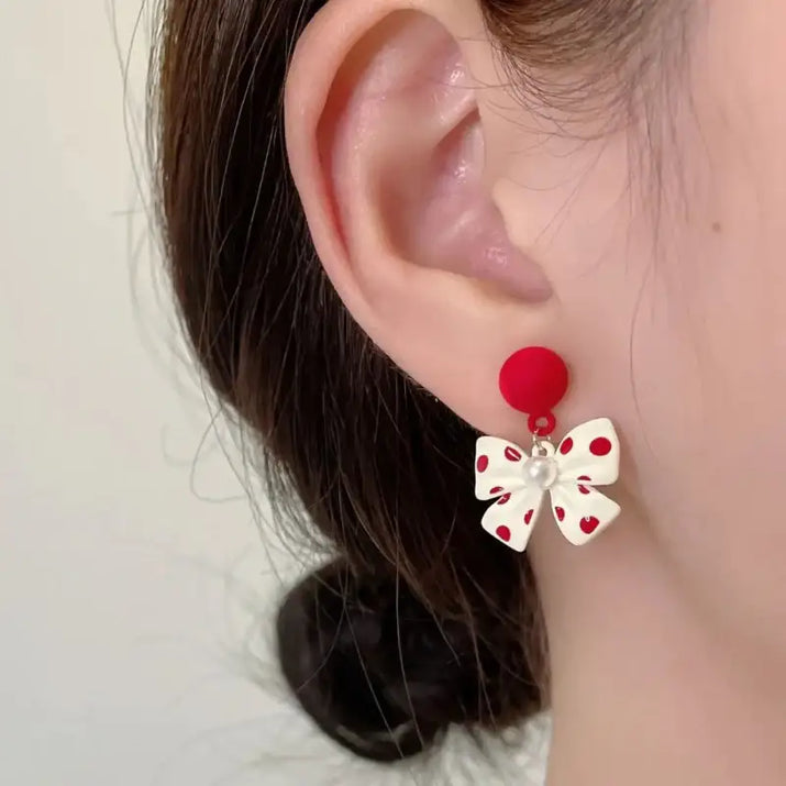 Red and white polka dot bow earrings.