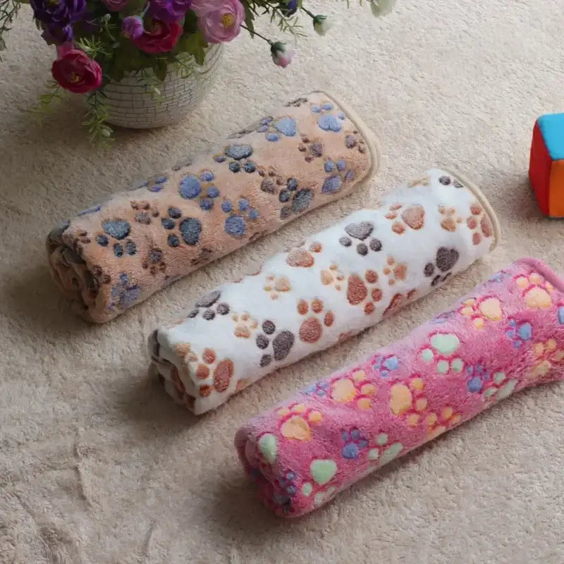 Three paw-printed plush rolls.