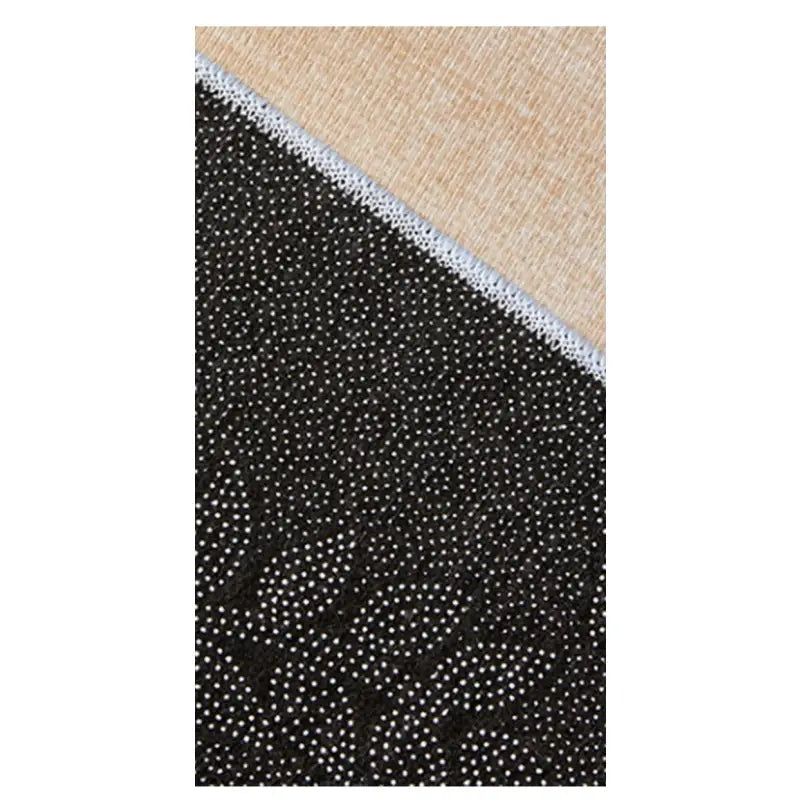 Black rug with white dots and tan backing for decorative home patio outdoor space