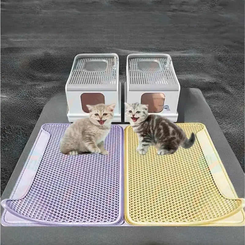 Two cat litter boxes with mats and kittens.