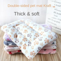 Stack of soft pet mats with paw prints.