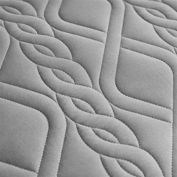 Gray quilted fabric with interwoven pattern.