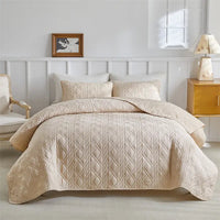 Beige quilted bedspread.