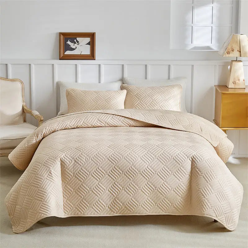 Beige quilted bedspread.