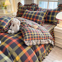 Plaid bedding set with ruffled edges.