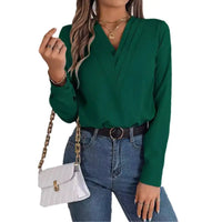 Woman’s green long-sleeved blouse.