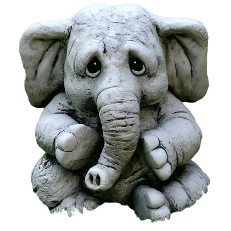 Sad-eyed, gray elephant statue.