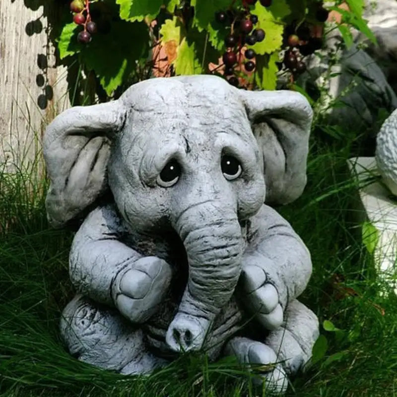 Gray, sad-eyed elephant statue.