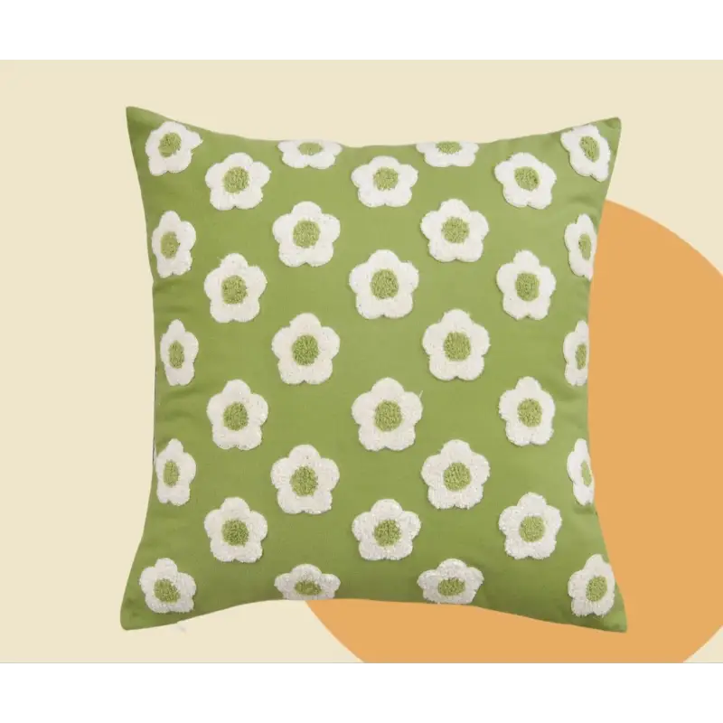 Green pillow with white flower pattern.