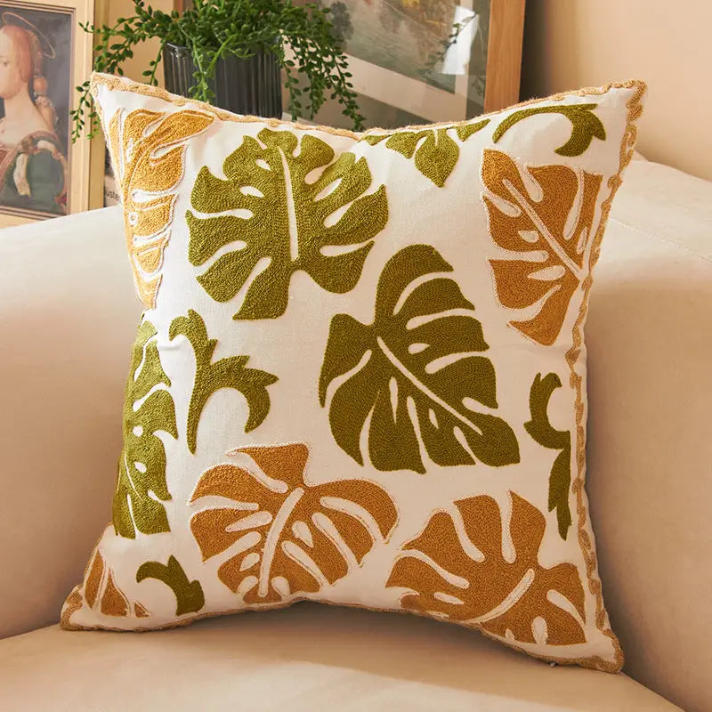 Embroidered monstera leaf pillow.