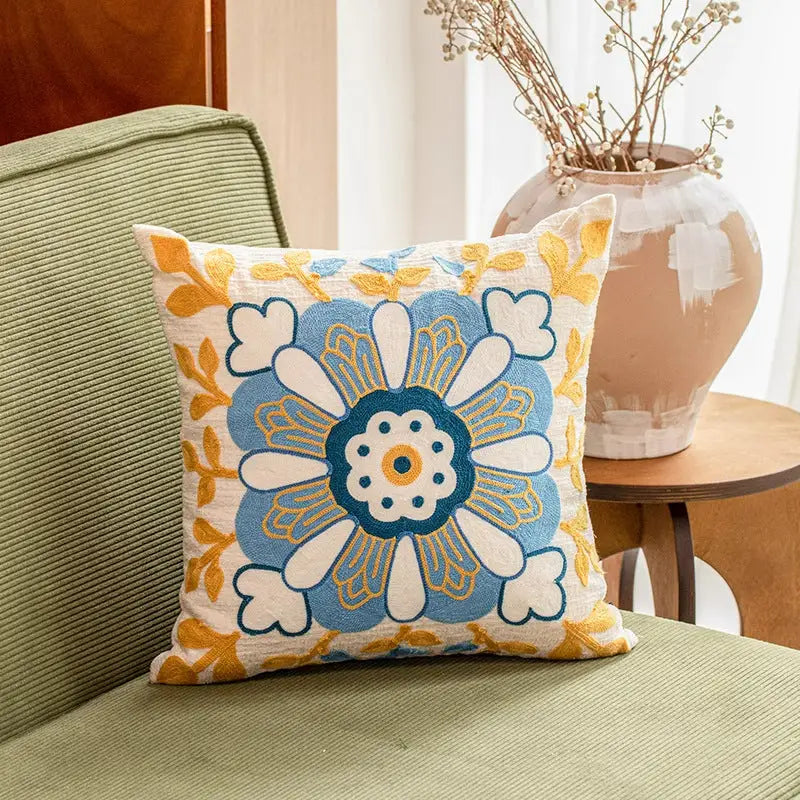 Embroidered floral throw pillow.