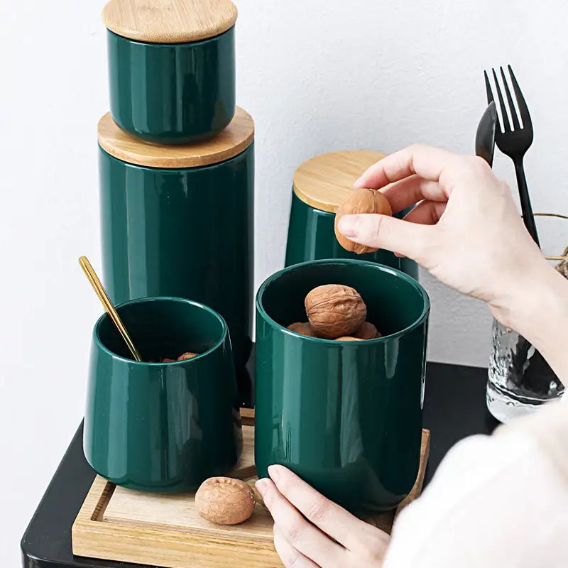 Green ceramic containers with wooden lids.