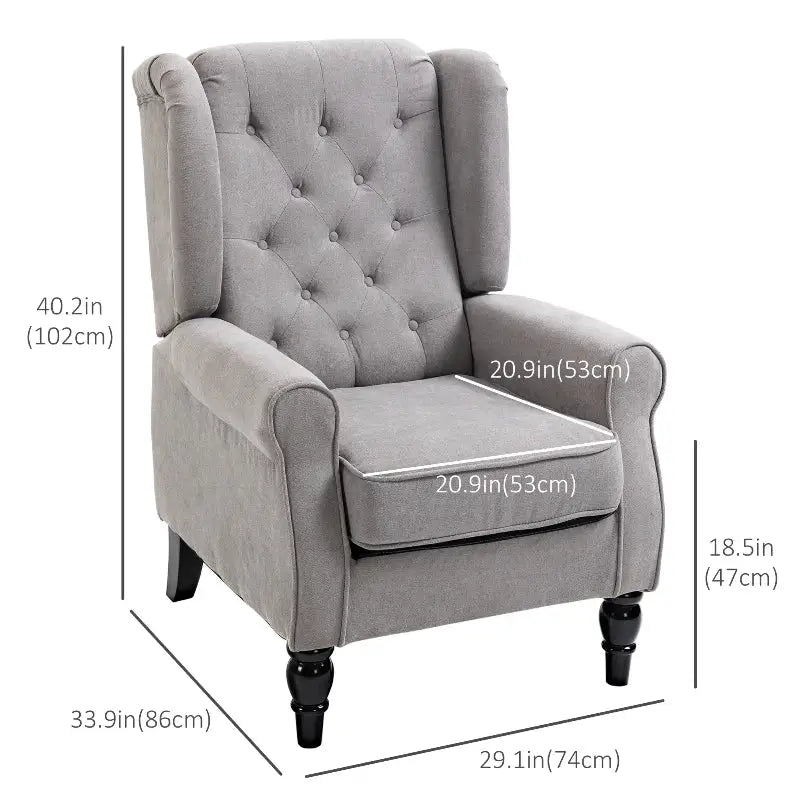 Gray upholstered armchair with button tufting.