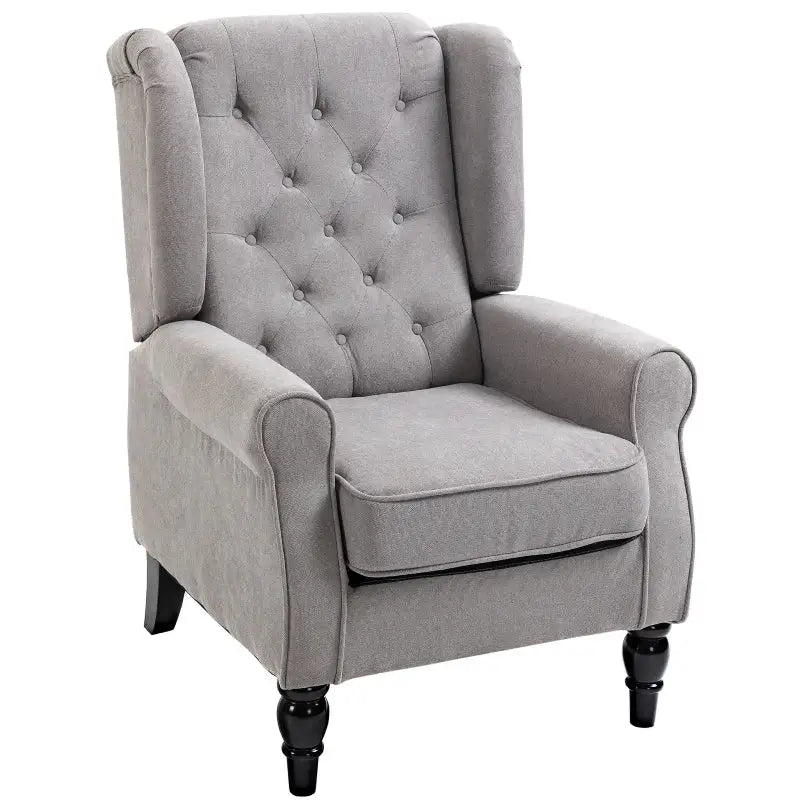 Gray upholstered armchair with button tufting.