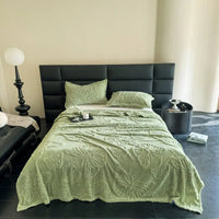 Green butterfly-patterned bedspread.