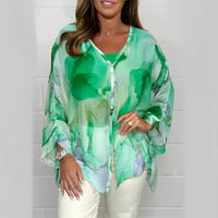 Green and white patterned blouse.