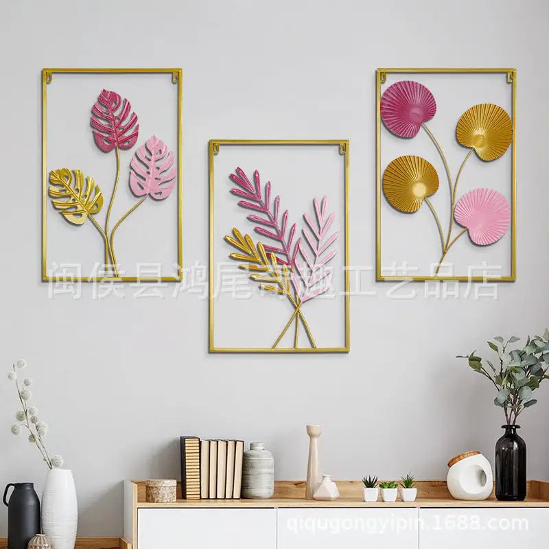 Three framed, colorful, metal leaf art pieces.