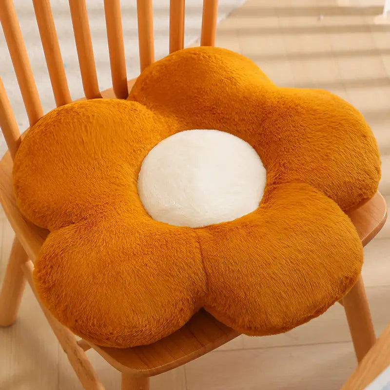 Orange flower-shaped plush cushion.
