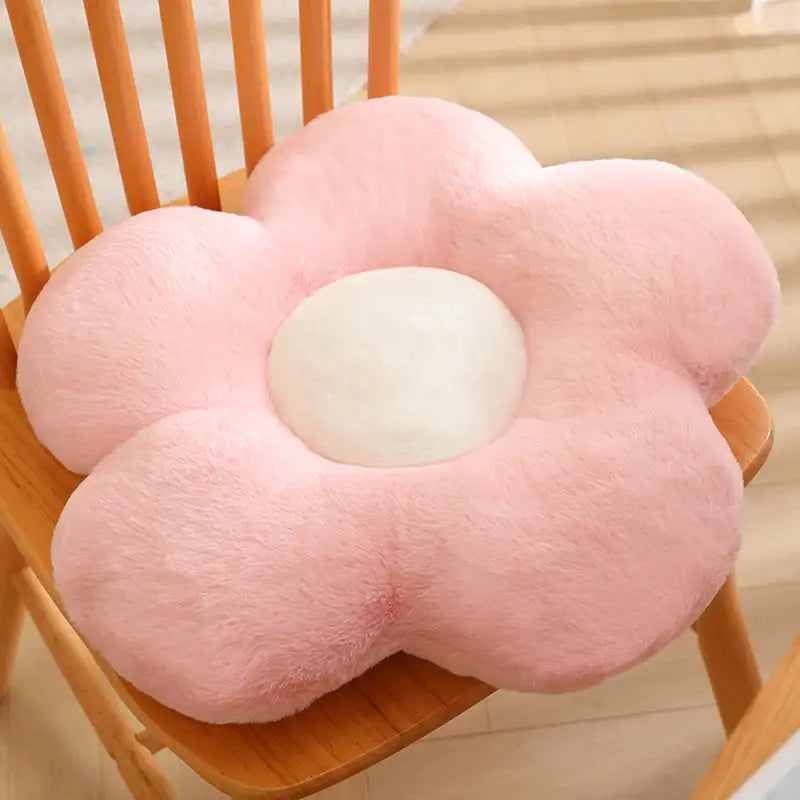 Pink flower-shaped plush cushion.