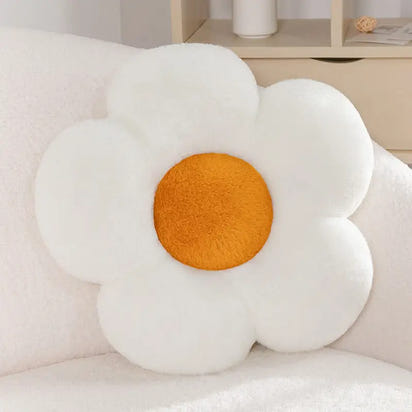 White flower-shaped plush pillow with orange center.