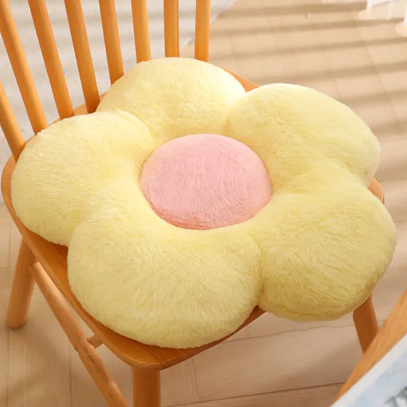 Yellow flower-shaped chair cushion with pink center.
