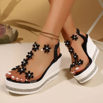 Black and clear floral wedge sandals.