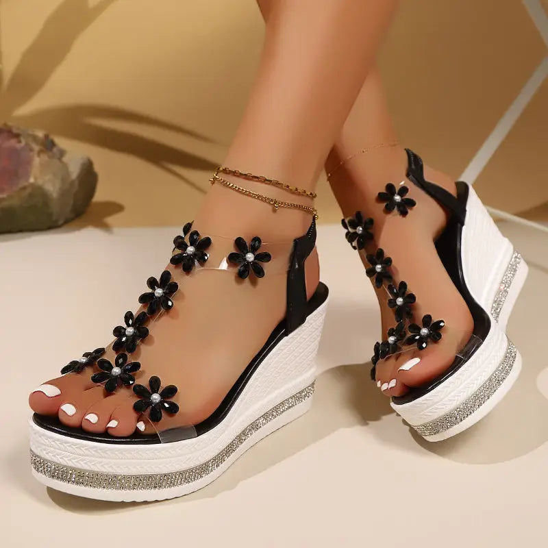 Black and clear floral wedge sandals.