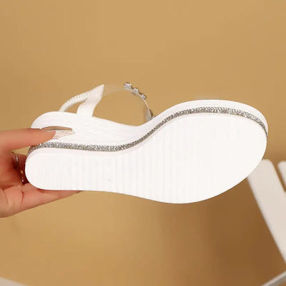 White platform sandal with rhinestone trim.
