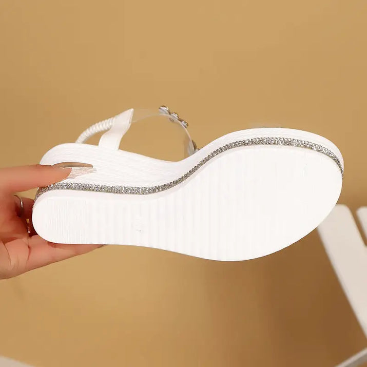 White platform sandal with rhinestone trim.
